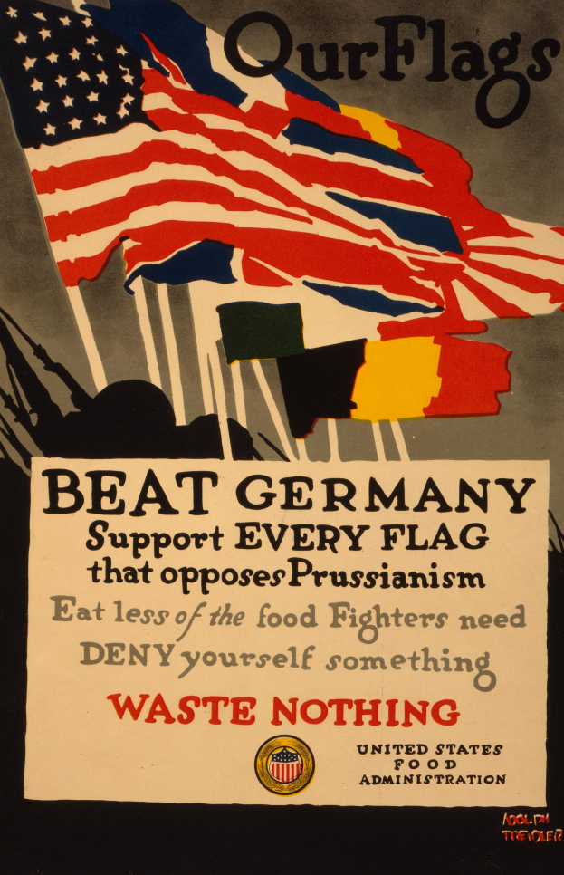 Ein Plakat mit einer roten, weißen und blauen Flagge mit einem weißen Stern, begleitet von fetter schwarzer Schrift, die "Unsere Flaggen schlagen Deutschland - Unterstützt jede Flagge, die gegen Preußentum kämpft" lautet, mit einem weißen Rand um die Schrift.