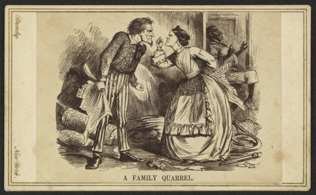 Ein Mann und eine Frau stehen sich in einem angespannten Moment während eines Familienstreits gegenüber, wobei der Mann ein Objekt in der Hand hält.