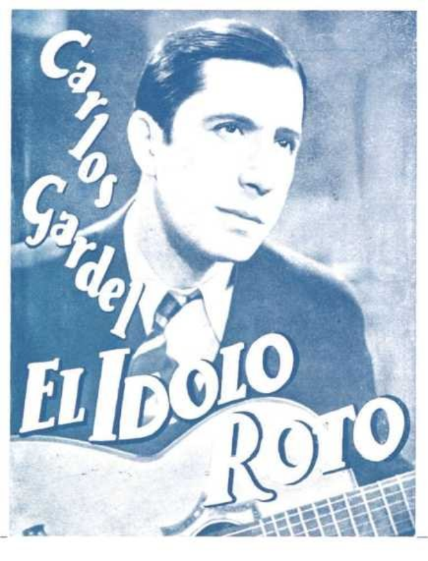 Plakat von El Idolo Roro, einem spanischen S├Ąnger-Songwriter, der eine Gitarre in einem wei├čem Hemd und einem schwarzen Anzug mit ernstem Gesichtsausdruck gegen einen hellblauen Hintergrund h├Ąlt.